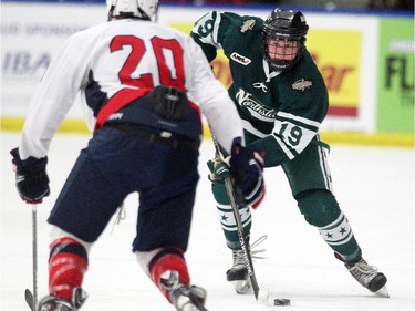 Calgary Northstars forward Adam Tisdale carried the puck towards Lethbridge Hurricanes forward Graham Dugdale during their Mac's AAA Midget Tournament at Max Bell Arena on December 27, 2014.