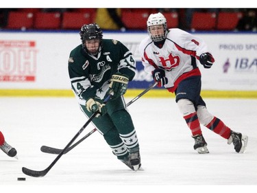 Calgary Northstars forward Brayden Dunn, left, carried the puck away from Lethbridge Hurricanes forward Ty Abbott during their Mac's AAA Midget Tournament at Max Bell Arena on December 27, 2014.