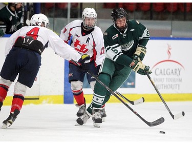 Calgary Northstars defenceman Kyle Yewchuk, right, slipped through the checks of Lethbridge Hurricanes defenceman Kyler Newman, left, and forward Devin Ruff during their Mac's AAA Midget Tournament at Max Bell Arena on December 27, 2014.