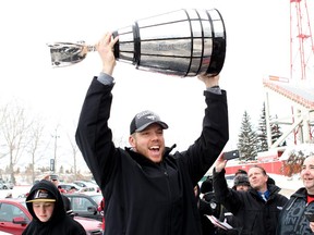 Calgary Stampeder offensive lineman Dan Federkeil celebrates with the Grey Cup as he gets off the team bus at McMahon Stadium on Monday, Dec. 1.  Calgary won the 102nd Grey Cup on Sunday in Vancouver with a 20-16 victory over the Hamilton Tiger-Cats.