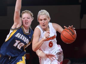 Dinos basketball player Clarise Jennings, right, has come to play with the university all the way from Australia.