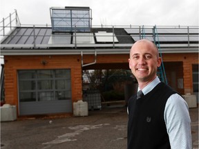 Ben Thibault, program director of electricity with the Pembina Institute, stands in front of one of SAIT's solar powered green building technologies projects. He and several other groups are calling for early phase-out of coal-fired electricity.