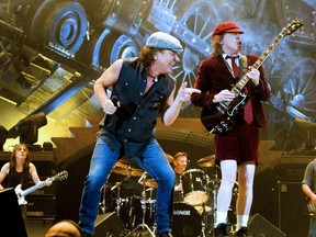 (FILES) A file picture taken on February 18, 2009 shows musicians from rockband AC/DC  Brian Johnson (L) and guitarist Angus Young performing at Telenor Arena on Fornebu, outside Oslo. One band member is retired with dementia and another has faced charges over a murder plot. But for the rest of AC/DC, the time-tested hard rock formula is still going strong. The Australian rockers next week release "Rock or Bust," some 40 years since Angus Young first donned his schoolboy outfit and took out his Gibson SG to play the sorts of power riffs that remain virtually unchanged on the latest album.