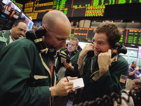 Traders work in the oil options pit at the New York Mercantile Exchange in this file photo.