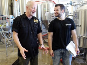 Peter Johnston-Berresford, coordinator of Olds College's Brewmaster and Brewery Operations Management program, discusses a beer being made by student Blain Weber in the school's teaching brewery.