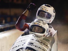 Latvia's Oskars Melbardis, left, and Dauments Dreiskens celebrate their win in the men's World Cup 2-man bobsled event in Calgary on Friday night.