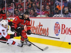 Calgary Flames defenceman Mark Giordano , seen battling Ottawa's Bobby Ryan during a Nov. 15 game, has been named the NHL's player of the month.