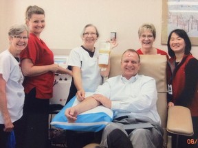 Provincial Court Judge Mark Tyndale is shown with Canadian Blood Services staff on June 4, 2013, when he donated blood for 800th time. In December 2013, Tyndale went to hospital and had emergency surgery for flesh-eating disease and likely was given some fluids including his own donated plasma to help save his life.