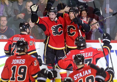 Calgary Flames Josh Jooris, left, celebrates his overtime winning goal on the Edmonton Oilers with teammate Dennis Wideman during their game at the Scotiabank Saddledome in Calgary on December 31, 2014.