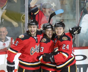 Calgary Flames Johnny Gaudreau, middle, celebrates his goal on Edmonton Oilers with teammates Mark Giordano, left and Jiri Hudler during first period action at the Scotiabank Saddledome in Calgary on December 27, 2014.