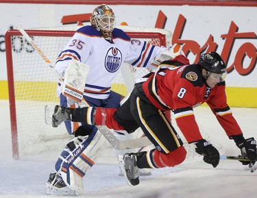 Calgary Flames Joe Colborne, right, collides with Edmonton Oilers goalie Viktor fasth during first period action at the Scotiabank Saddledome in Calgary on December 27, 2014.