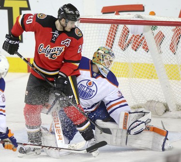Calgary Flames Curtis Glencross and Edmonton Oilers goalie Ben Scrivens during third period action at the Scotiabank Saddledome in Calgary.