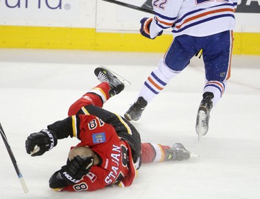 Calgary Flames Matt Stajan collides with Edmonton Oilers Keith Aulie during their game at the Scotiabank Saddledome in Calgary on December 31, 2014.