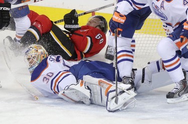 Edmonton Oilers goalie Ben Scrivens collides with Calgary Flames Markus Granlund during third period action at the Scotiabank Saddledome in Calgary.