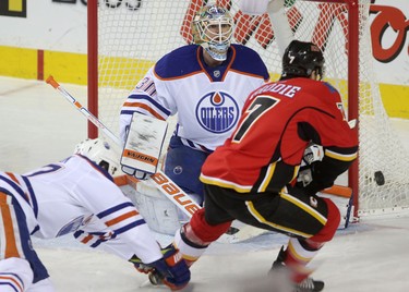 Calgary Flames TJ Brodie tries to score on Edmonton Oilers goalie Ben Scrivens during their game at the Scotiabank Saddledome in Calgary on December 31, 2014.