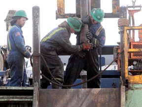 A Precision Drilling crew works at an oil well in North Dakota in this 2012 file photo.