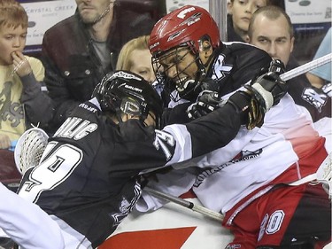 Calgary Roughnecks' Travis Cornwall take a hit from Edmonton Rush's Nic Bilic during an exhibition game at the Saddledome in Calgary, on December 20, 2014.