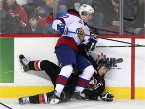 Calgary Hitmen left winger Kenton Helgesen was driven into the boards by Edmonton Oil Kings left winger Brandon Ralph during the first period of their WHL game on Wednesday night. The Oil Kings won 3-1.