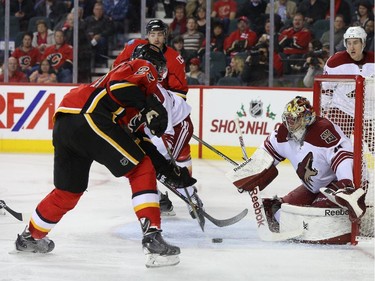 Mike Smith of the Arizona Coyotes makes a pad save against Sean Monahan of the Calgary Flames at Scotiabank Saddledome in Calgary on Tuesday December 2, 2014.