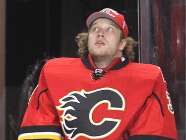 Ailing goalie Karri Ramo, suffering from an  illness, watches from the bench during the third period of the Calgary Flames 2-1 loss, their 7th in a row, to the Dallas Stars at the Saddledome Friday night December 19, 2014.