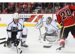 Calgary Flames forward Curtis Glencross and Los Angeles Kings' Matt Greene scramble in front goaltender Jonathan Quick during the Flames 2-1 win Monday night.