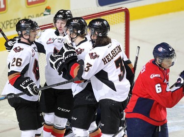 Members of the Calgary Hitmen, from left, left winger Connor Rankin, right winger Chase Lang, centre Pavel Karnaukhov and left winger Kenton Helgesen celebrated after their line scored against the Lethbridge Hurricanes during WHL action at the Scotiabank Saddledome on December 30, 2014.