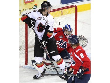 Calgary Hitmen left winger Kenton Helgesen watched as a shot sailed over the shoulder and into the net of Lethbridge Hurricanes goalie Stuart Skinner during WHL action at the Scotiabank Saddledome on December 30, 2014.