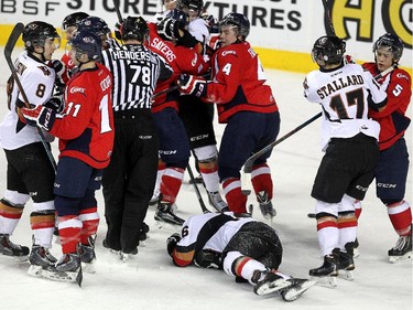 The lines gathered to scrap as Calgary Hitmen left winger Connor Rankin laid on the ice after being thrown down to it by Lethbridge Hurricanes left winger Jamal Watson during WHL action at the Scotiabank Saddledome on December 30, 2014.