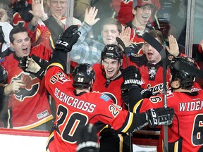 Sean Monahan of the Calgary Flames celebrates with teammates after scoring the winner in overtime against the Colorado Avalanche at the Saddledome on Thursday.