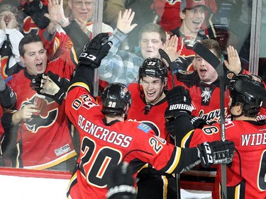 Sean Monahan of the Calgary Flames celebrates with teammates after scoring the winner in overtime against the Colorado Avalanche at the Saddledome Thursday evening December 4, 2014.