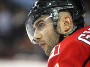 Calgary Flames captain Mark Giordano waits for a faceoff against the Colorado Avalanche during the second period at the Saddledome in this file photo from December 4, 2014.