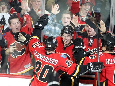 Sean Monahan of the Calgary Flames celebrates with teammates after scoring the winner in overtime against the Colorado Avalanche at the Saddledome Thursday evening December 4, 2014.