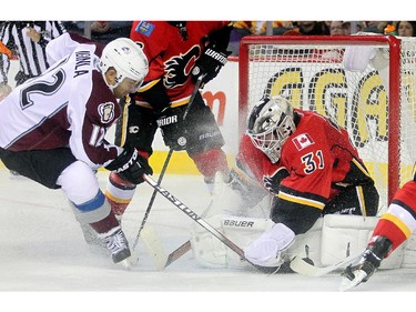 Netminder Karri Ramo of the Calgary Flames robs Jarome Iginla of the Colorado Avalanche on the doorstep during the second period  at the Saddledome Thursday evening December 4, 2014.