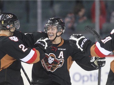 Elliott Peterson of the Calgary Hitmen celebrates with linemates Jake Bean and Jordy Stallard after scoring on the Edmonton Oil Kings in the  first period at the Saddledome Friday night December 5, 2014.