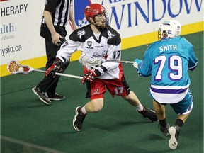 Curtis Dickson, seen battling Rochester Knighthawks defenceman Sid Smith during NLL action last season, is coming off a 44-goal campaign with the Roughnecks.