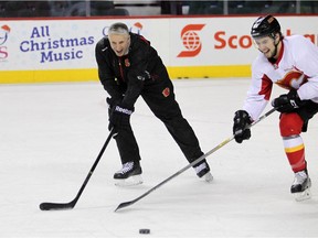 Calgary Flames head coach Bob Hartley got in a couple of plays with centre Josh Jooris during practice on Monday.