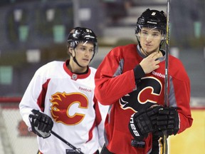 Calgary Flames forwards Joe Colborne, front, and Mason Raymond practise on Monday. As the players try to snap a five-game losing streak, a surprising mumps outbreak in the NHL that hasn't hit the Flames yet, is in the back of their minds.