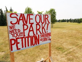 A petition sign stands in a park that is slated for a francophone school in Scenic Acres on Monday July 15, 2014.