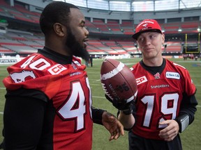 Calgary Stampeders' quarterback Bo Levi Mitchell, right, pretends to use a football as a microphone as he interviews teammate defensive lineman Shawn Lemon on the Saturday before the Grey Cup. Lemon is now off to try to impress NFL teams.