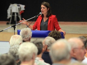 Then-Wildrose leader Danielle Smith speaks at a September 2013 town hall addressing the actions of the RCMP during the June flood in High River.