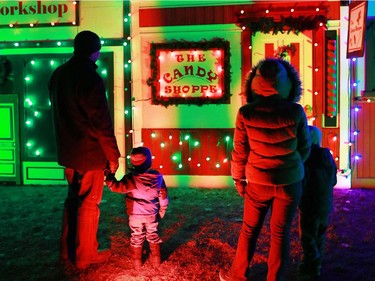 The Pituch family checks out a Christmas village part of the large Christmas lights display at Spruce Meadows on Sunday December 14, 2014.