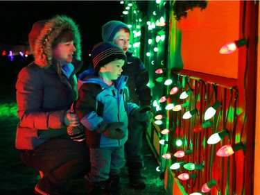 The Pituch family checks out a Christmas village part of the large Christmas lights display at Spruce Meadows on Sunday December 14, 2014.