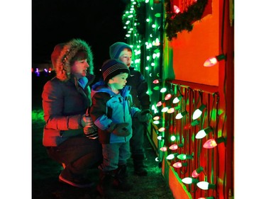 The Pituch family checks out a Christmas village part of the large Christmas lights display at Spruce Meadows on Sunday December 14, 2014.