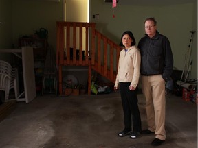 On Dec. 10, 2014, Hope Lee and her husband David Eagle stand in the attached garage of their Calgary home, which thieves accessed after breaking into their car that had been left at the Park and Jet lot at the airport.