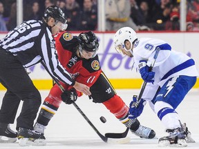 Mikael Backlund #11 of the Calgary Flames faces-off against Tyler Johnson #9 of the Tampa Bay Lightning during an NHL game at Scotiabank Saddledome on October 21, 2014 in Calgary, Alberta, Canada.