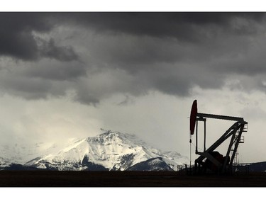 A pumpjack sits in the shadows of the Rocky Mountains near the Legacy Oil and Gas Little Chicago Gas Plant southwest of Turner Valley