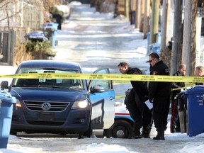 Homicide investigators at the scene where  Duane Laybourne's body was found in the back alley of the 100-block of 28th Avenue NE on February 4, 2013.