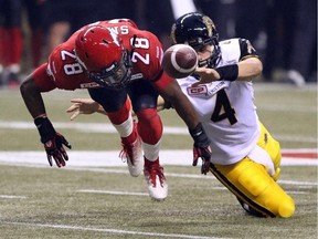 Calgary Stampeders defender Brandon Smith works to recover the ball  vs. Hamilton Tiger Cats QB Zach Collaros during the 2014 Grey Cup in Vancouver on Sunday. He is among a large group of Stamps eligible for free agency.