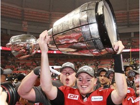 The Calgary Stampeders quarterback Bo Levi Mitchell holds the Grey Cup after the team won the 2014 Grey Cup in Vancouver on Sunday November 30, 2014.