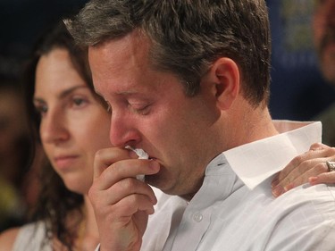 Rod O'Brien breaks down alongside his wife Jennifer as the couple address a press conference regarding their missing son Nathan at Calgary Police headquarters Wednesday July 2, 2014.